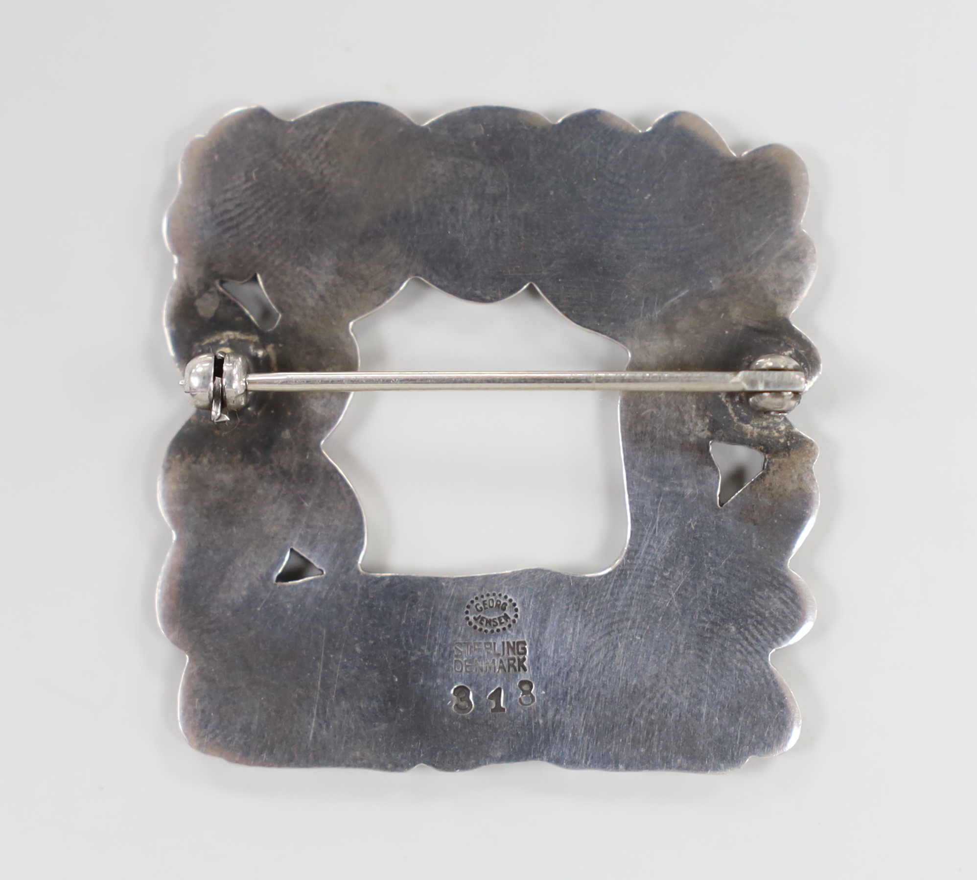 A Georg Jensen sterling recumbent deer and squirrel amongst foliage square brooch, design no. 318, 37mm.